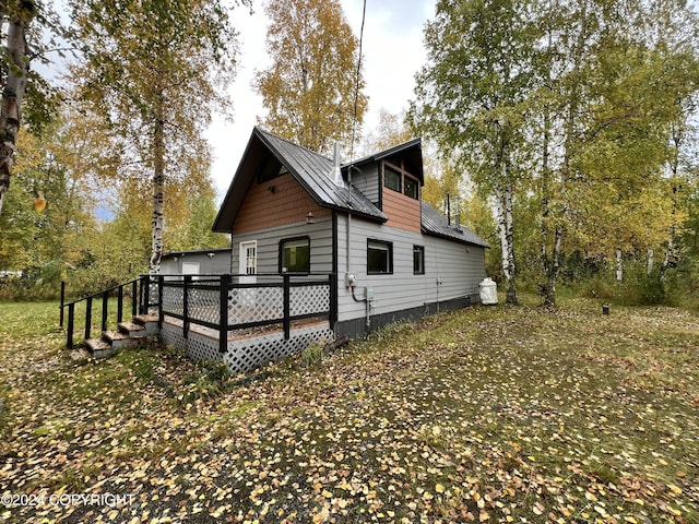 rear view of house featuring a deck
