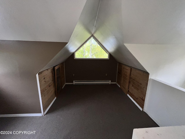 bonus room with a baseboard heating unit, vaulted ceiling, baseboards, and dark colored carpet