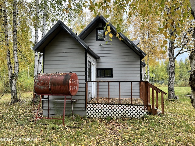 rear view of property with a deck and heating fuel