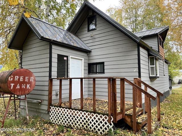 rear view of house featuring metal roof