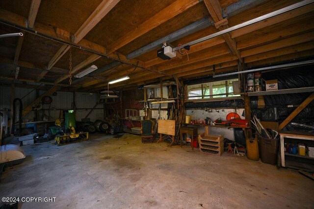 garage with a garage door opener and a workshop area