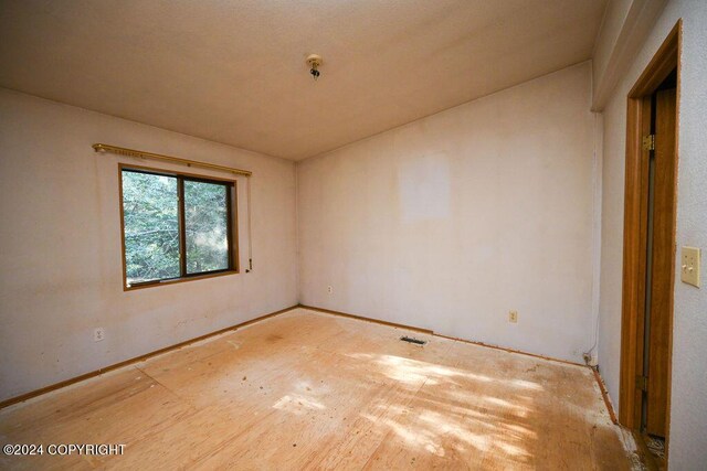 unfurnished room featuring vaulted ceiling