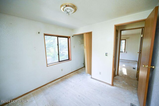 unfurnished bedroom with multiple windows