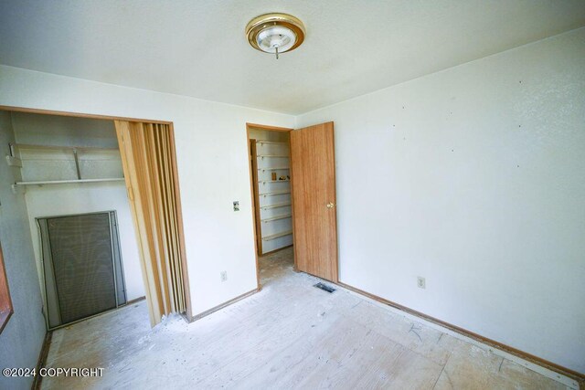 unfurnished bedroom with a closet