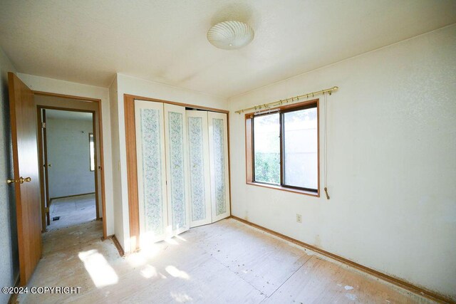 unfurnished bedroom with a closet