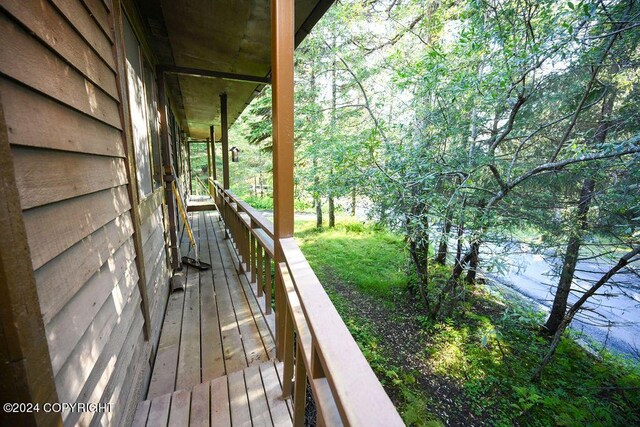 wooden terrace featuring a water view