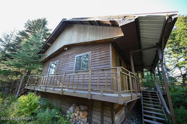 view of property exterior featuring a wooden deck