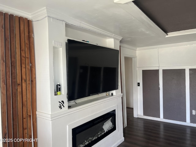 unfurnished living room featuring dark wood-type flooring and crown molding