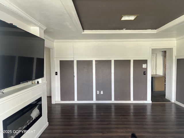 unfurnished living room featuring wood finished floors and ornamental molding