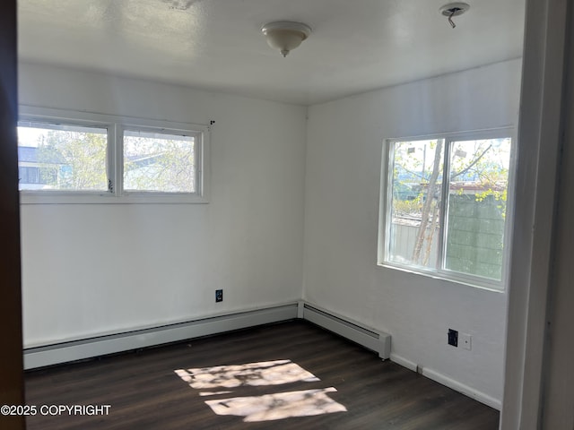 spare room with plenty of natural light, dark wood-style floors, and baseboards