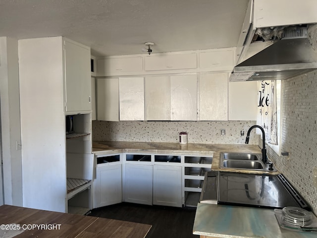 kitchen with a sink, exhaust hood, decorative backsplash, dark wood-style flooring, and white cabinetry