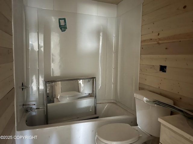 full bathroom featuring toilet, tub / shower combination, vanity, and wood walls