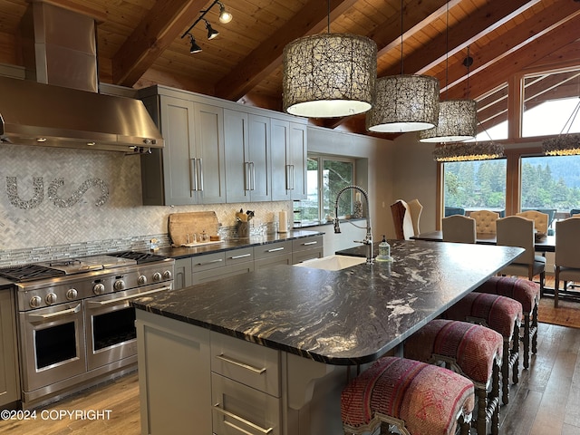 345 C St, Seldovia, AK 99663 - kitchen featuring decorative backsplash, light wood finished floors, double oven range, ventilation hood, and wooden ceiling