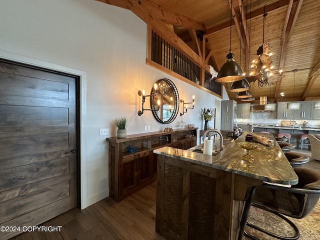 345 C St, Seldovia, AK 99663 - kitchen featuring beamed ceiling, dark wood finished floors, a sink, an inviting chandelier, and wooden ceiling