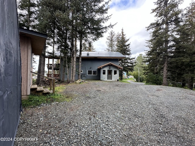 345 C St, Seldovia, AK 99663 - view of front of house featuring driveway and metal roof