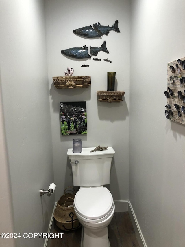 345 C St, Seldovia, AK 99663 - bathroom featuring baseboards, wood finished floors, and toilet