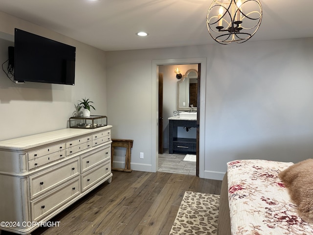 345 C St, Seldovia, AK 99663 - bedroom with recessed lighting, an inviting chandelier, dark wood-style flooring, baseboards, and connected bathroom