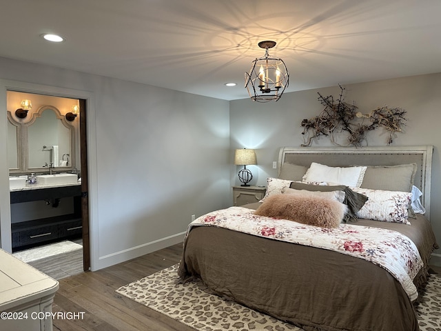 345 C St, Seldovia, AK 99663 - bedroom featuring a chandelier, baseboards, wood finished floors, recessed lighting, and ensuite bath