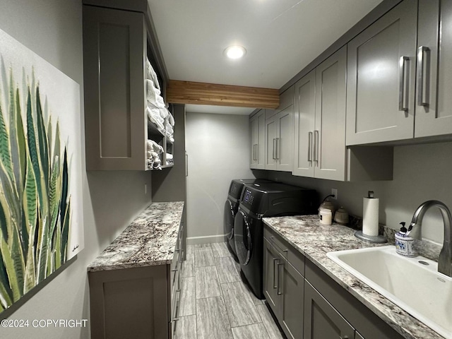 345 C St, Seldovia, AK 99663 - washroom with a sink, wood finish floors, baseboards, washer and dryer, and cabinet space