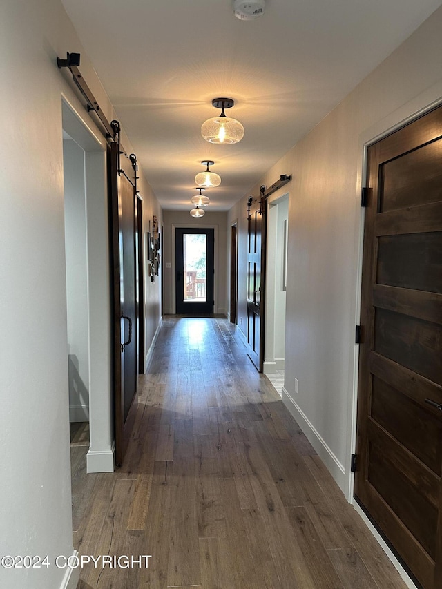 345 C St, Seldovia, AK 99663 - corridor with baseboards, a barn door, and wood finished floors