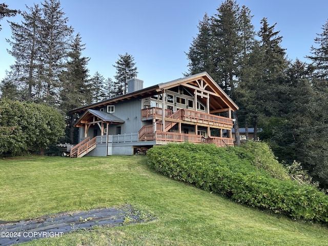 345 C St, Seldovia, AK 99663 - rear view of property featuring a chimney, a yard, and a wooden deck