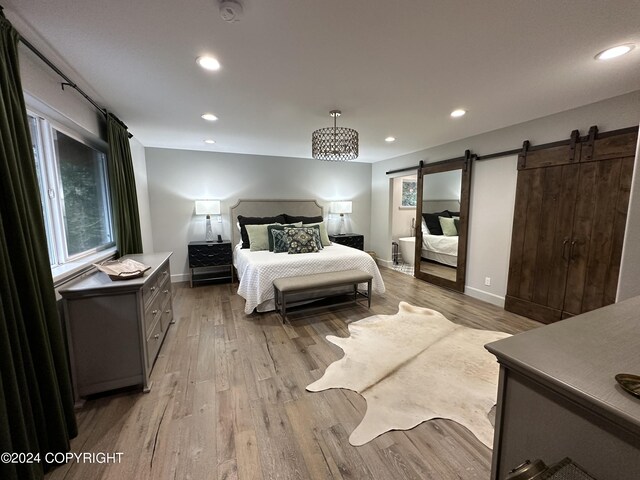 345 C St, Seldovia, AK 99663 - bedroom with recessed lighting, baseboards, a barn door, and light wood-type flooring