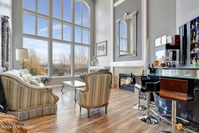 8100 Sky Mountain Ln, Anchorage, AK 99502 - living area with a high ceiling, a fireplace, and wood finished floors