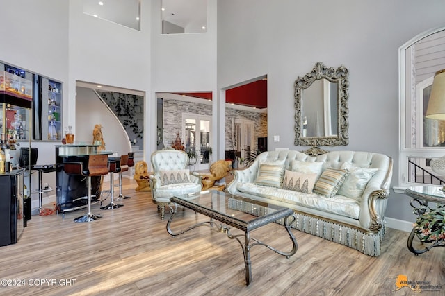 8100 Sky Mountain Ln, Anchorage, AK 99502 - living area featuring a towering ceiling, wood finished floors, bar area, and baseboards