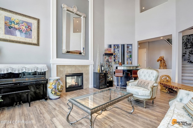 8100 Sky Mountain Ln, Anchorage, AK 99502 - living area with wood finished floors, a towering ceiling, and a fireplace