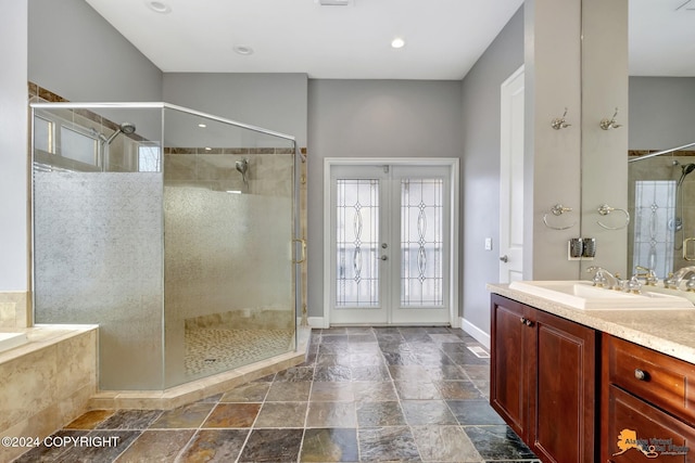 8100 Sky Mountain Ln, Anchorage, AK 99502 - full bathroom featuring french doors, a shower stall, baseboards, vanity, and stone tile flooring