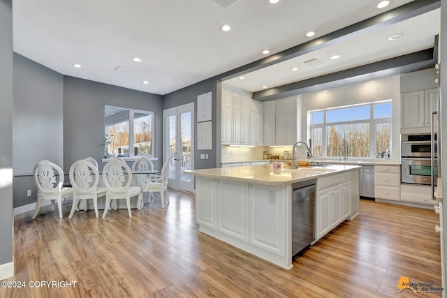 8100 Sky Mountain Ln, Anchorage, AK 99502 - kitchen featuring appliances with stainless steel finishes, white cabinetry, plenty of natural light, light wood-type flooring, and recessed lighting