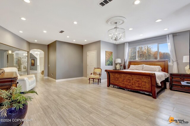 8100 Sky Mountain Ln, Anchorage, AK 99502 - bedroom with a chandelier, arched walkways, recessed lighting, baseboards, and light wood-style flooring