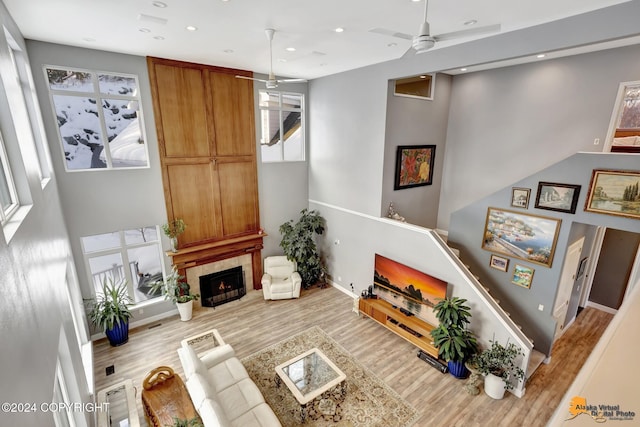 8100 Sky Mountain Ln, Anchorage, AK 99502 - living area featuring wood finished floors, ceiling fan, recessed lighting, baseboards, and a fireplace