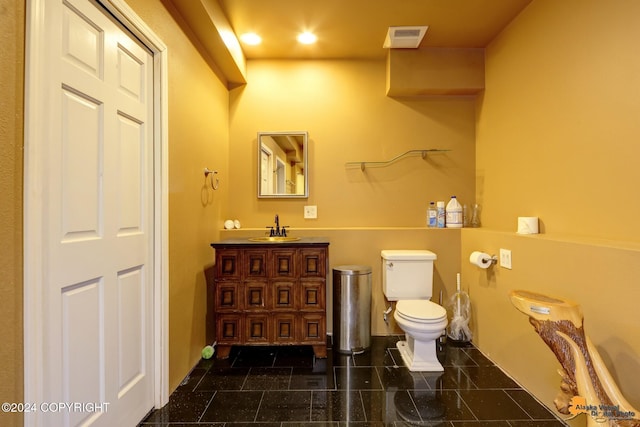 8100 Sky Mountain Ln, Anchorage, AK 99502 - bathroom with vanity, toilet, baseboards, and granite tiled floors