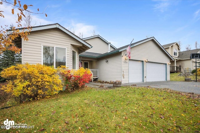 view of front of house with a front yard and a garage