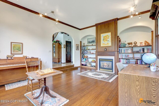 living room featuring crown molding and hardwood / wood-style flooring