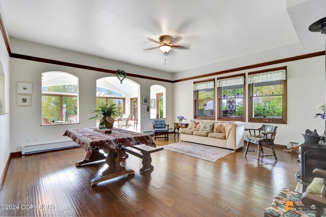 living room featuring wood-type flooring, ceiling fan, and a baseboard radiator