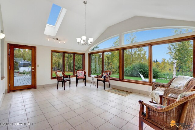 sunroom / solarium featuring vaulted ceiling with skylight, a chandelier, and a healthy amount of sunlight