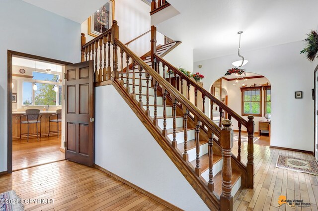 stairs with hardwood / wood-style floors and a wealth of natural light