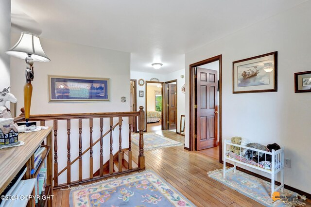 corridor with light hardwood / wood-style flooring