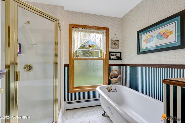 bathroom featuring plus walk in shower, a baseboard heating unit, plenty of natural light, and tile patterned floors