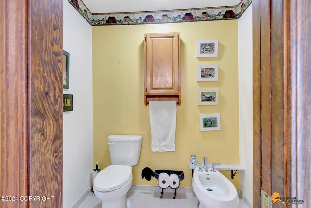 bathroom featuring a bidet, tile patterned floors, and toilet