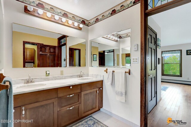bathroom featuring vanity, hardwood / wood-style flooring, and a baseboard radiator