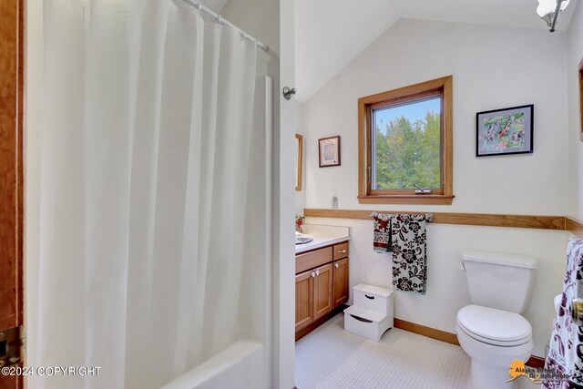 bathroom featuring lofted ceiling, vanity, toilet, and tile patterned floors