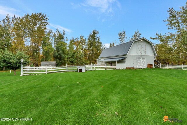 view of yard featuring an outdoor structure and a rural view