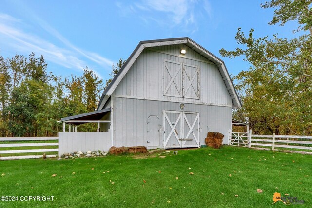 view of outbuilding with a yard