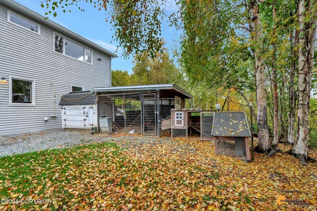 rear view of property featuring an outdoor structure