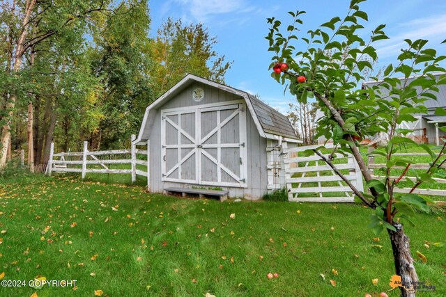 view of outbuilding with a yard