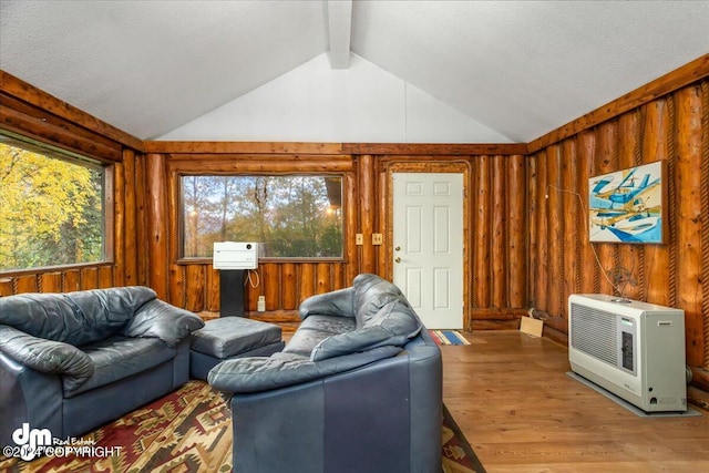 living room with vaulted ceiling with beams, wooden walls, heating unit, and hardwood / wood-style flooring