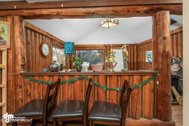 bar with hardwood / wood-style flooring and lofted ceiling